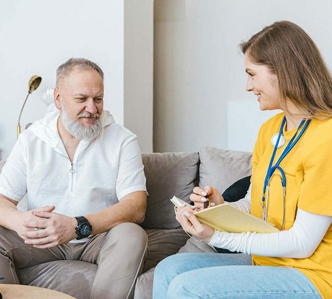 A care aide interviews her patient in Waldorf, MD