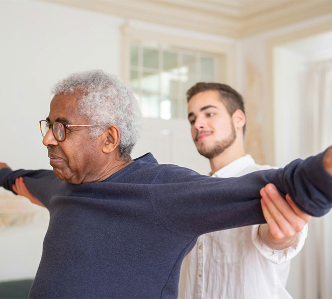 A caregiver helps a patient with exercises in Potomac, MD