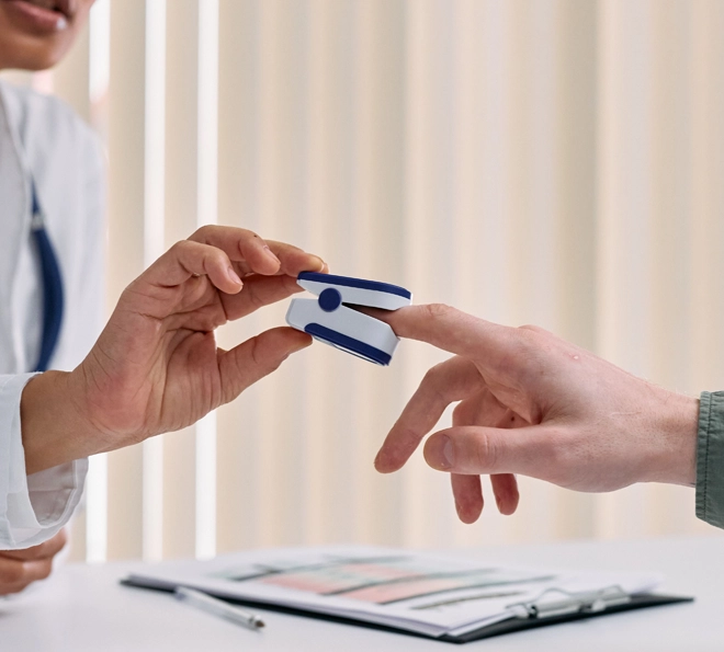 A live-in home health aide puts a oximeter on the finger of her patient in Waldorf, MD